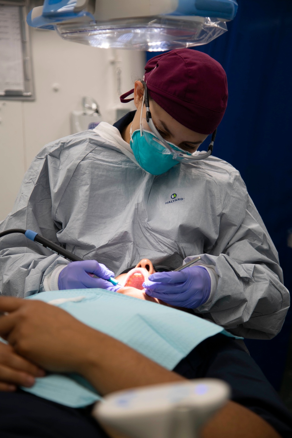 Abraham Lincoln Hospital Corpsman conducts dental cleaning