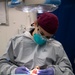 Abraham Lincoln Hospital Corpsman conducts dental cleaning