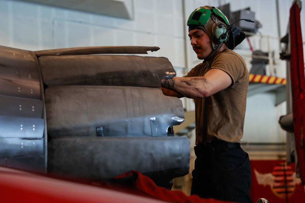 Abraham Lincoln Sailor conducts aircraft maintenance