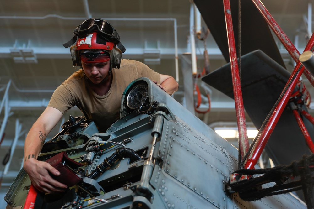 Abraham Lincoln Sailor conducts aircraft maintenance