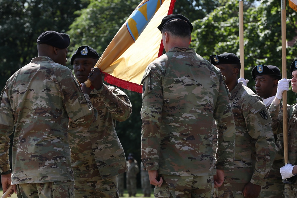 Command Sgt. Maj. Kofie Primus receives guidon from Maj. Gen. James Smith