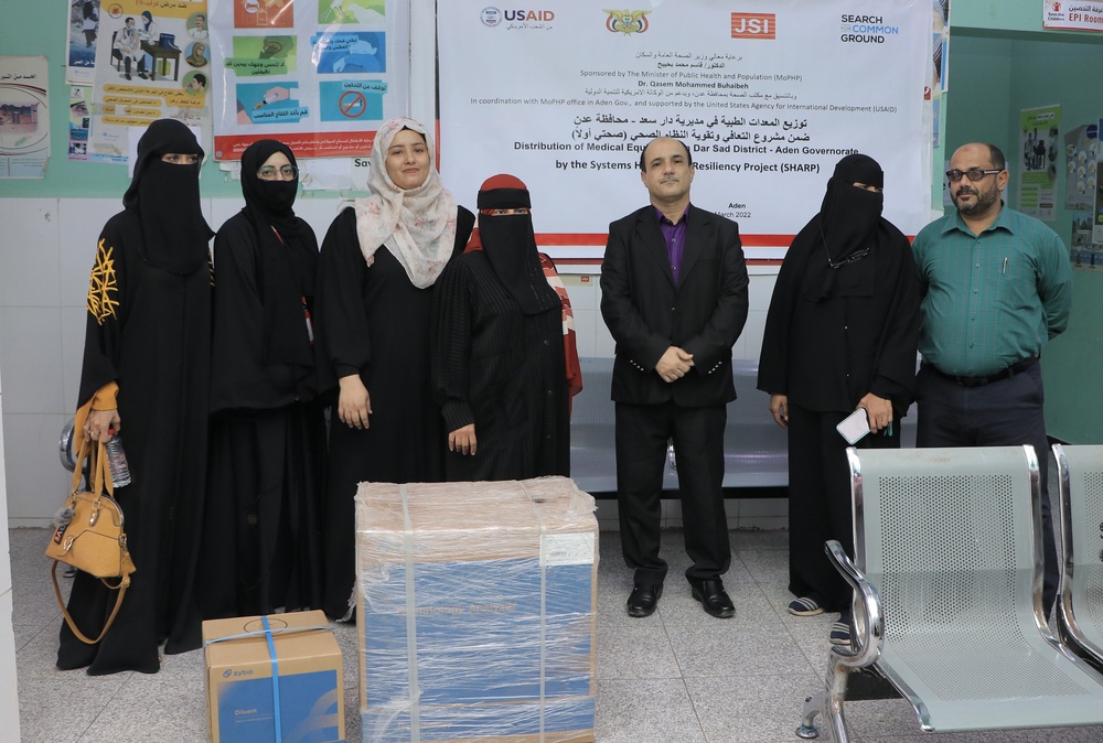 Officials from the Al-Lohom Health Center in Yemen receive complete blood count machines provided with USAID funding