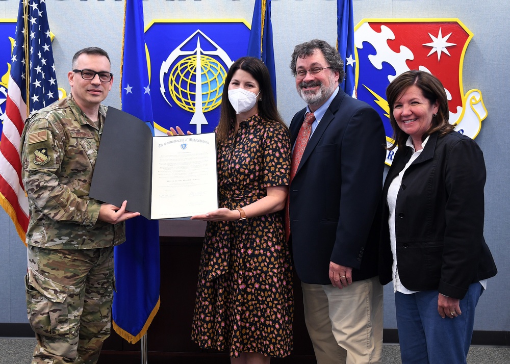 Base officials present proclamation to Bedford school officials