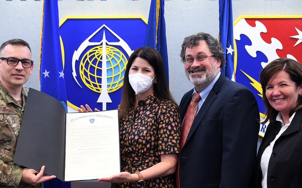 Base officials present proclamation to Bedford school officials