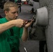 USS George H.W. Bush Sailor Installs Equipment