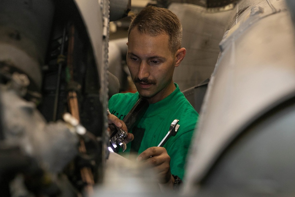 USS George H.W. Bush Sailor Installs Equipment