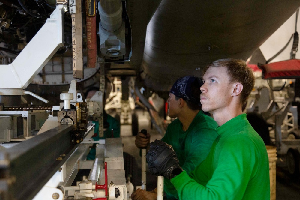 Abraham Lincoln sailors perform aircraft maintenance