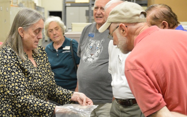 Museum volunteers visit artifact storage facility