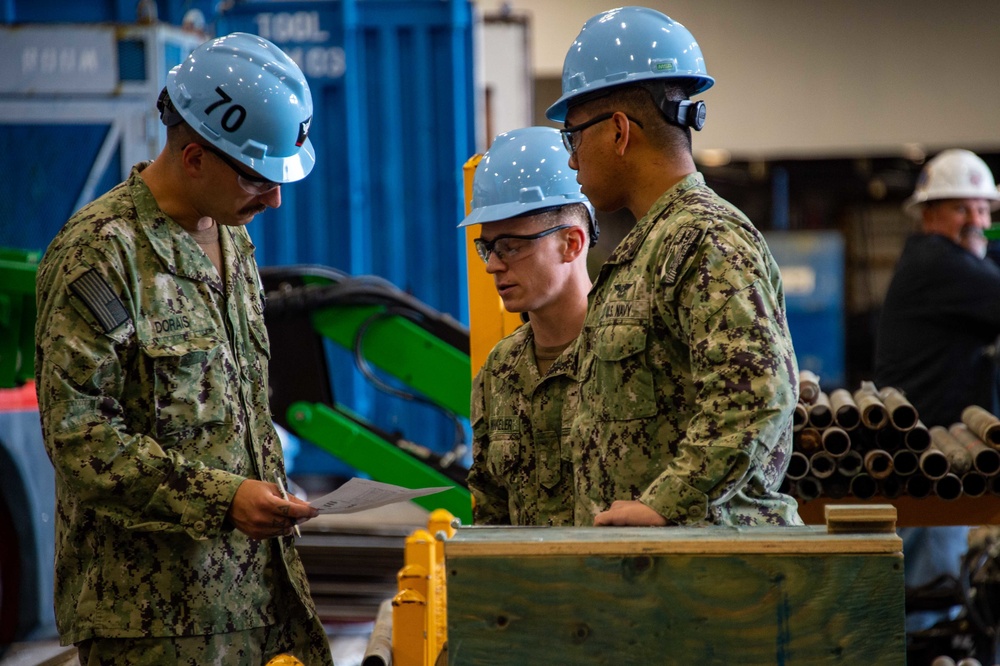 Sailors review inventory in the hangar bay