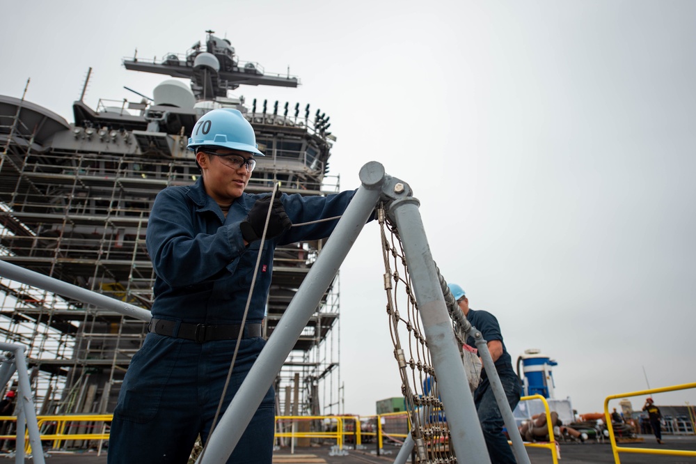 USS Carl Vinson (CVN 70) Sailors Work In Port