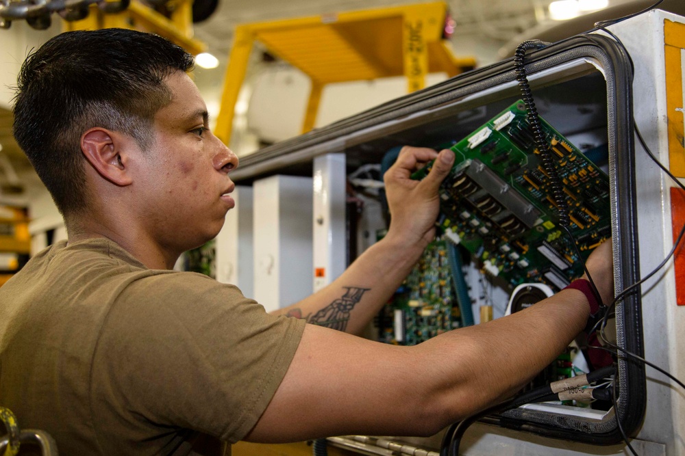 Abraham Lincoln Sailor conducts maintenance