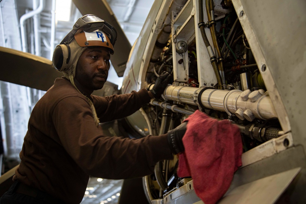 Abraham Lincoln Sailor conducts aircraft maintenance