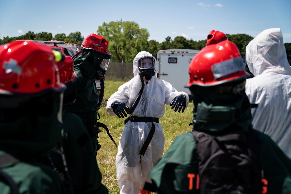 Airmen and Soldiers suit up for a decontamination exercise