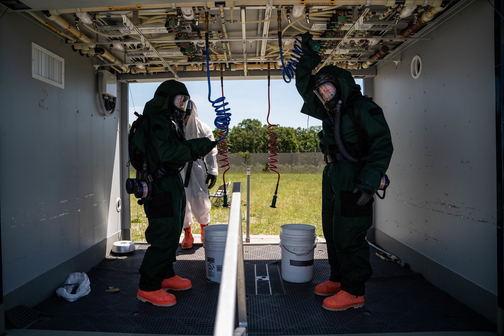 Airmen and Soldiers suit up for a decontamination exercise