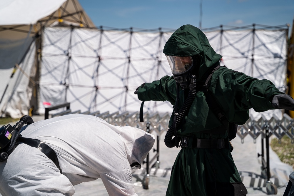 Airmen and Soldiers suit up for a decontamination exercise