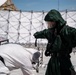 Airmen and Soldiers suit up for a decontamination exercise