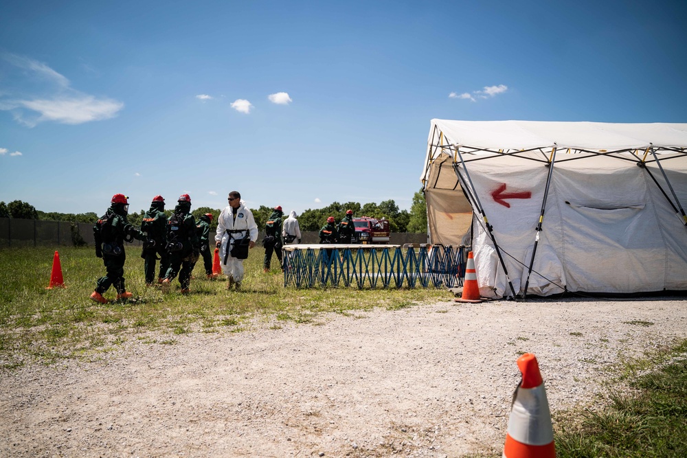 Airmen and Soldiers suit up for a decontamination exercise