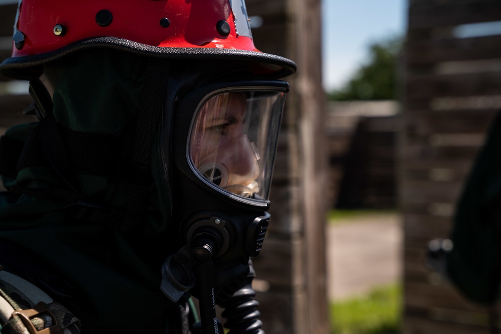 Airmen and Soldiers suit up for a decontamination exercise