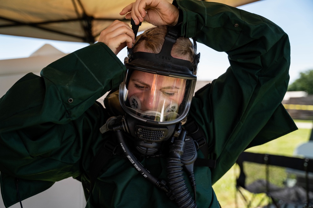 Airmen and Soldiers suit up for a decontamination exercise