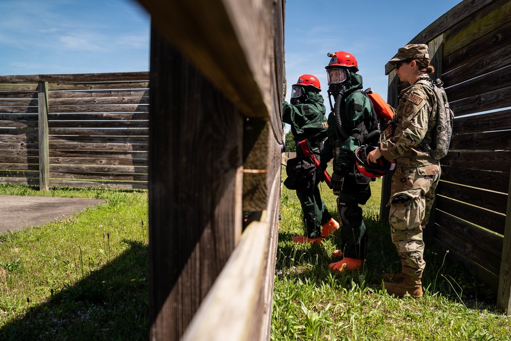 Airmen and Soldiers suit up for a decontamination exercise