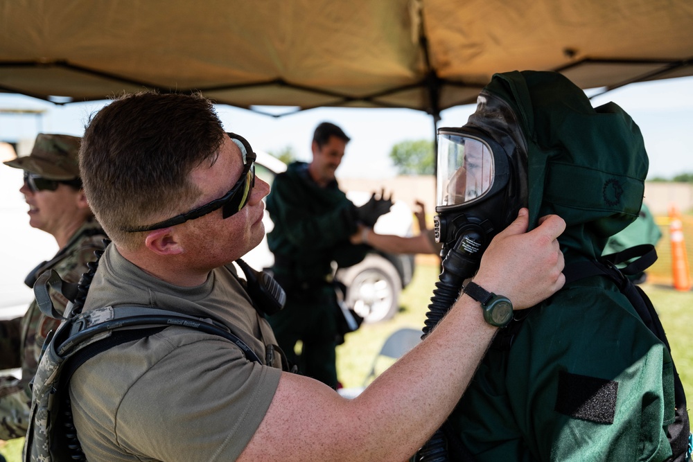 Airmen and Soldiers suit up for a decontamination exercise