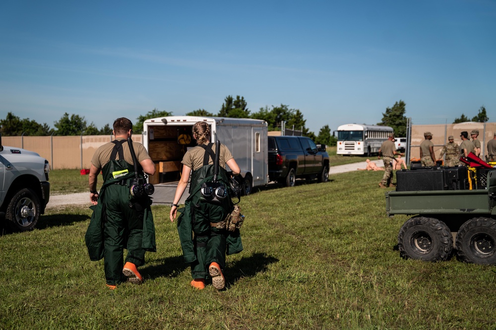 Airmen and Soldiers suit up for a decontamination exercise