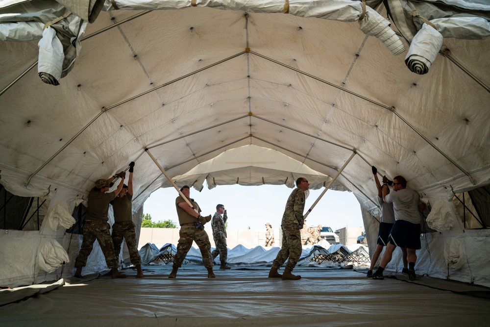 Airmen and Soldiers suit up for a decontamination exercise