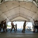 Airmen and Soldiers suit up for a decontamination exercise