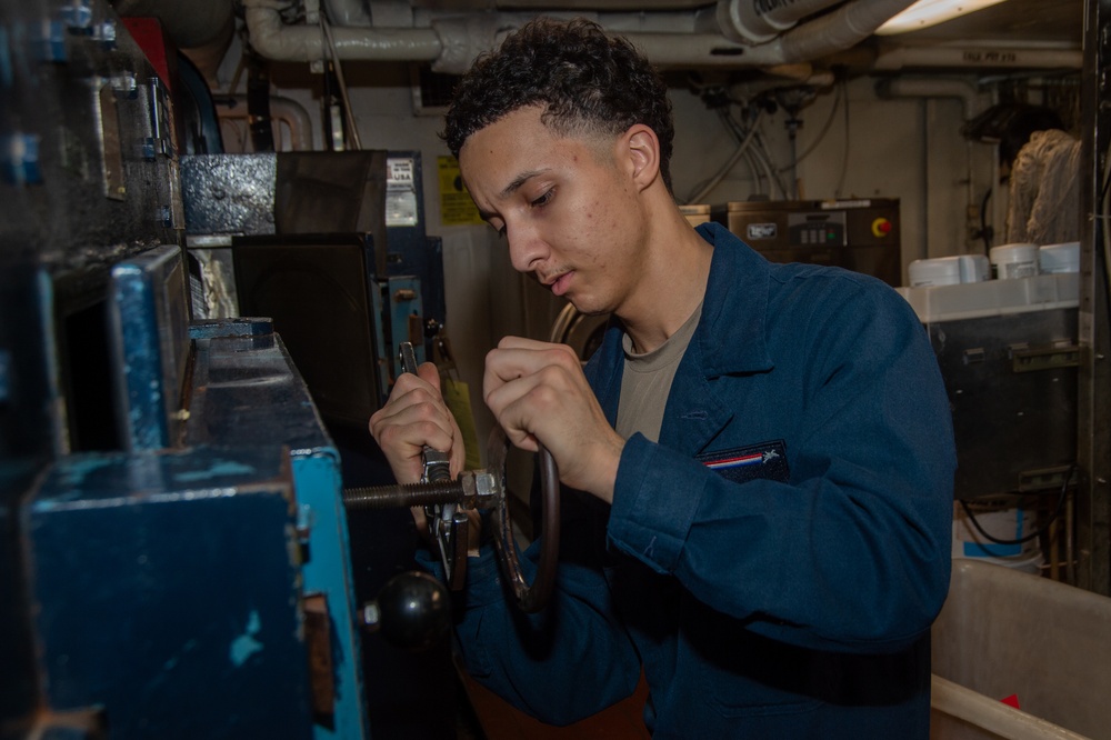 USS Ronald Reagan (CVN 76) Sailor performs maintenance on laundry machines