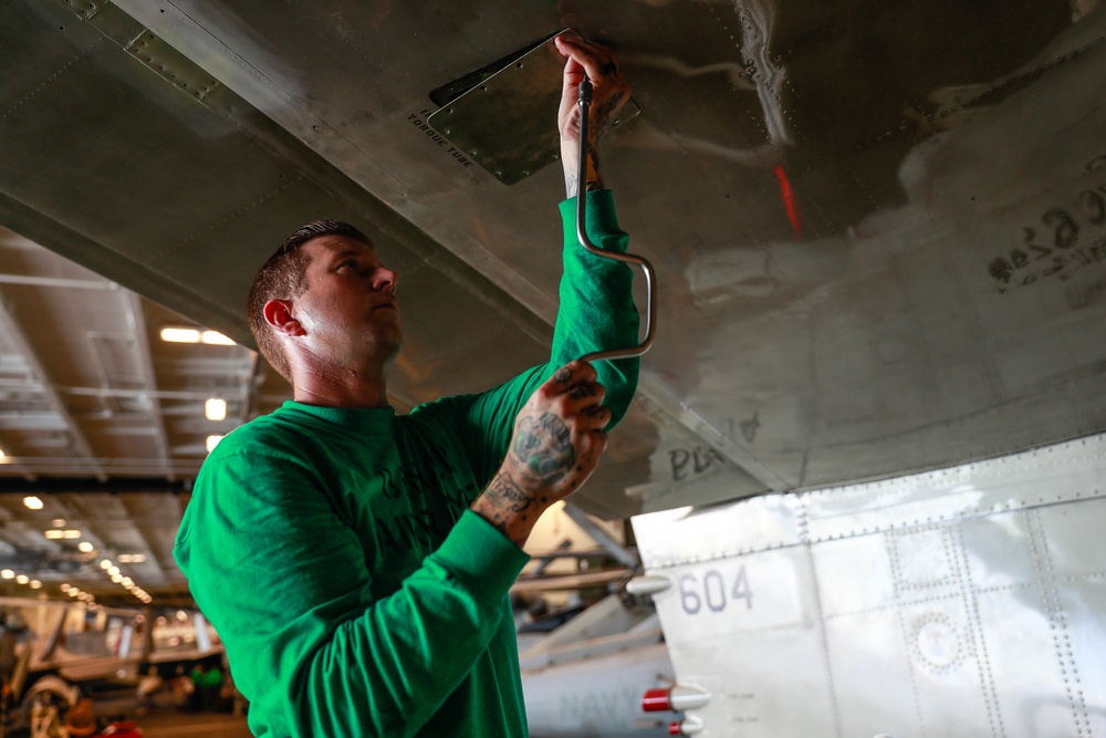 Abraham Lincoln Sailor conducts aircraft maintenance