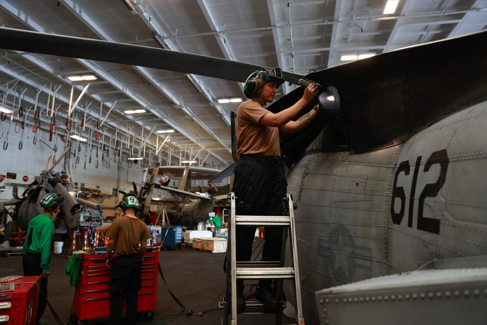 Abraham Lincoln Sailor conducts aircraft maintenance