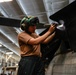 Abraham Lincoln Sailor conducts aircraft maintenance