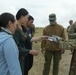 U.S. Soldier gives supplies to Mongolian villagers