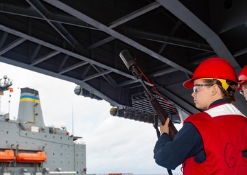 USS Ronald Reagan (CVN-76) conducts a replenishment-at-sea
