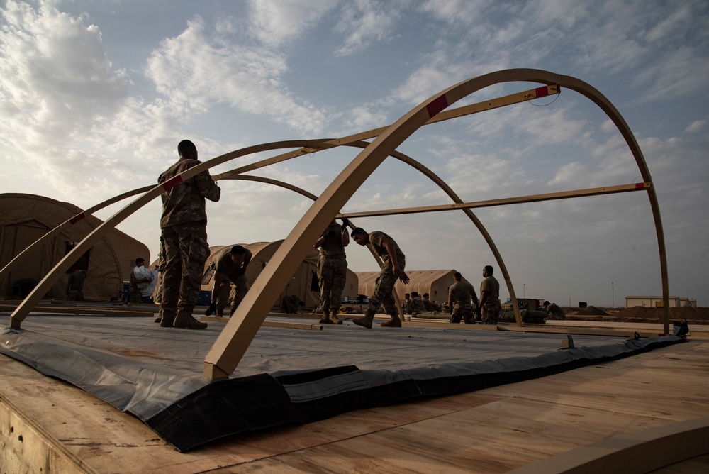 U.S. Airmen and Soldiers construct personnel tents at Camp Lemonnier, Djibouti