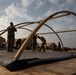 U.S. Airmen and Soldiers construct personnel tents at Camp Lemonnier, Djibouti