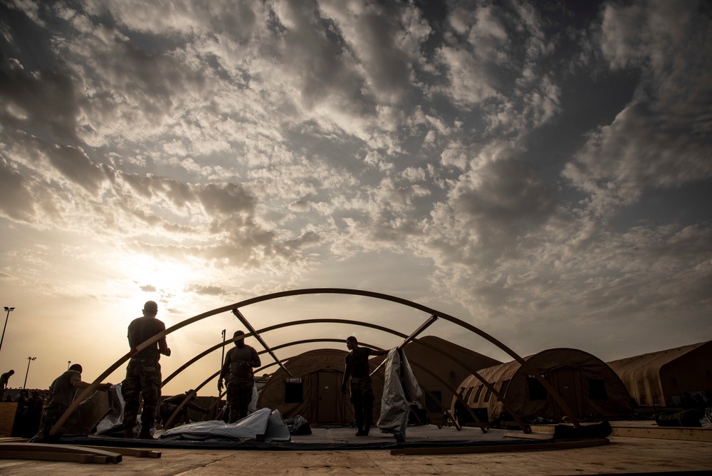 U.S. Airmen and Soldiers construct personnel tents at Camp Lemonnier, Djibouti