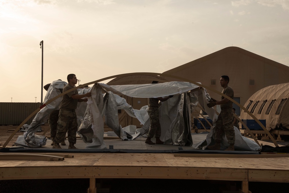 U.S. Airmen and Soldiers construct personnel tents at Camp Lemonnier, Djibouti