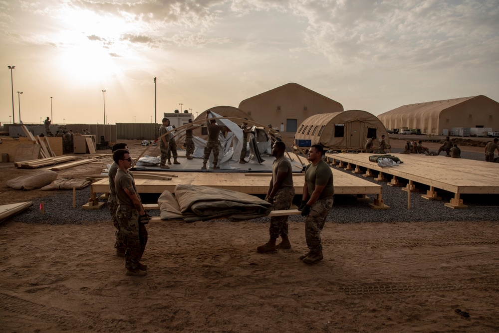 U.S. Airmen and Soldiers construct personnel tents at Camp Lemonnier, Djibouti