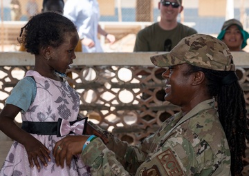 U.S. Airmen and Soldiers provide personal care items and build a swing set at Chabelley Village, Djibouti