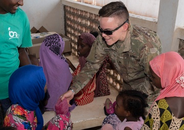 U.S. Airmen and Soldiers provide personal care items and build a swing set at Chabelley Village, Djibouti