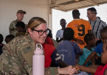 U.S. Airmen and Soldiers provide personal care items and build a swing set at Chabelley Village, Djibouti