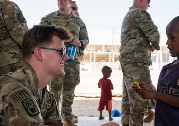 U.S. Airmen and Soldiers provide personal care items and build a swing set at Chabelley Village, Djibouti