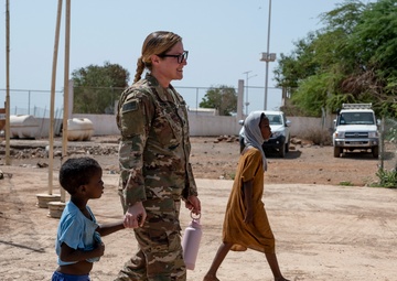 U.S. Airmen and Soldiers provide personal care items and build a swing set at Chabelley Village, Djibouti