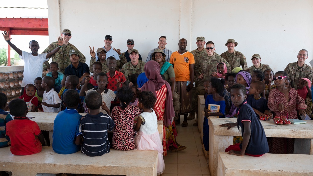U.S. Airmen and Soldiers provide personal care items and build a swing set at Chabelley Village, Djibouti