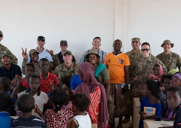 U.S. Airmen and Soldiers provide personal care items and build a swing set at Chabelley Village, Djibouti