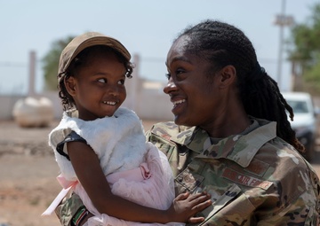 U.S. Airmen and Soldiers provide personal care items and build a swing set at Chabelley Village, Djibouti