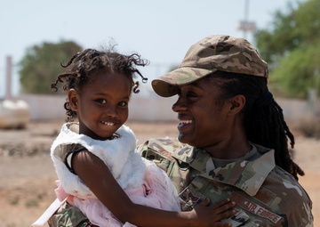 U.S. Airmen and Soldiers provide personal care items and build a swing set at Chabelley Village, Djibouti