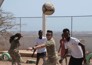 U.S. Airmen and Soldiers provide personal care items and build a swing set at Chabelley Village, Djibouti