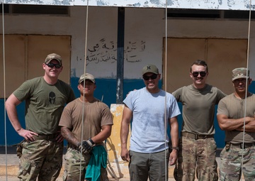 U.S. Airmen and Soldiers provide personal care items and build a swing set at Chabelley Village, Djibouti